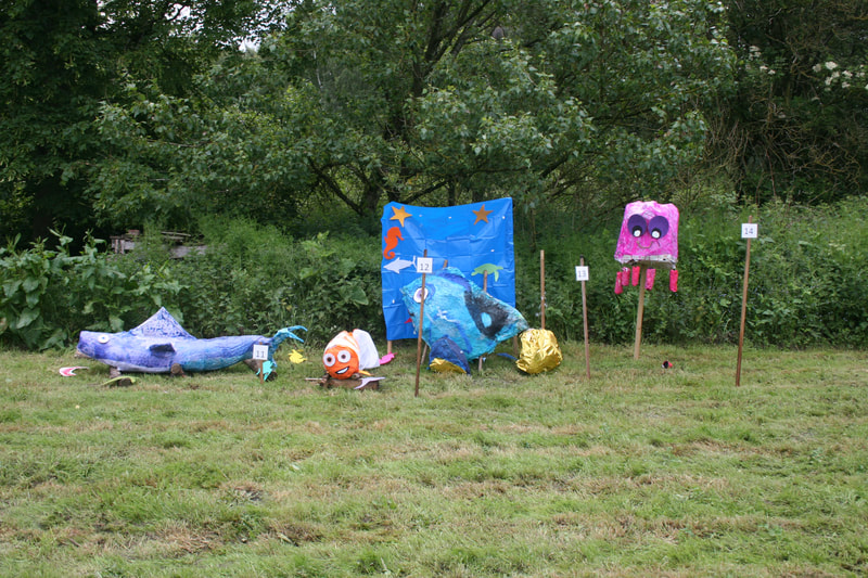 Four Finding Nemo scarecrows - a shark, Nemo, Dory and a pink jellyfish